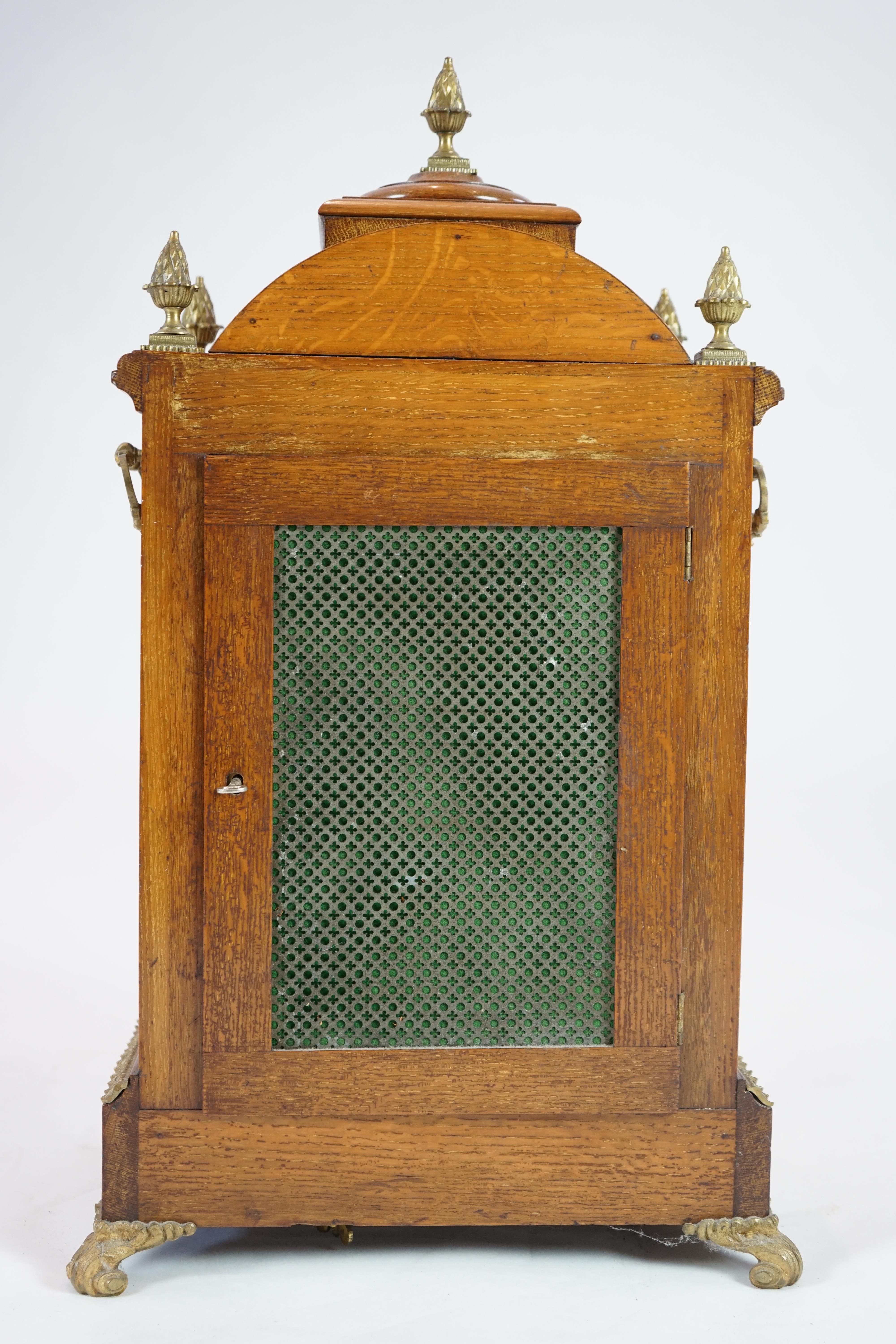 A late Victorian ormolu mounted golden oak cased eight day chiming bracket clock and bracket